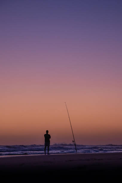 istock Fishing at the beach with a sunset 1283107562