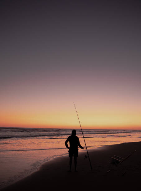 istock Fishing at the beach with a sunset 1283107566