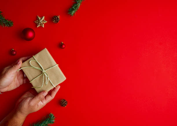 istock Flat lay Creative composition of Man holding Christmas gift box 1283108260
