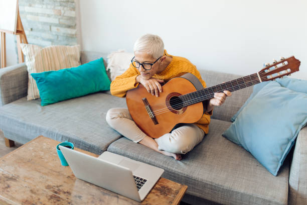 istock Senior woman having an online guitar class 1283110921