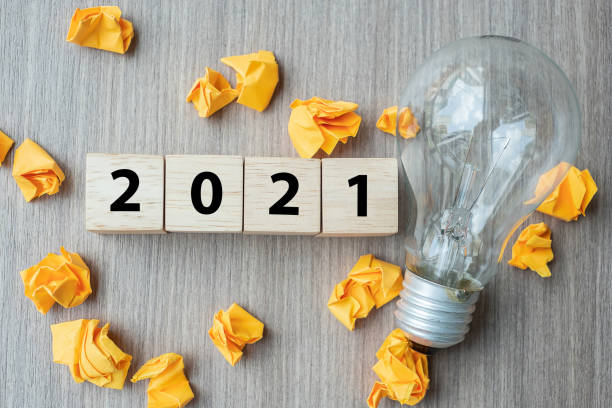 istock 2021 text wood cube blocks and crumbled paper with lightbulb on wooden table background. New Year New Ideas, Creative, Innovation, Imagination, inspiration, Resolution, Strategy and goal concept 1283112257