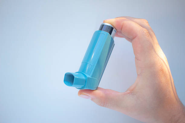 istock A person holding an asthma inhaler on a clear background 1283113816