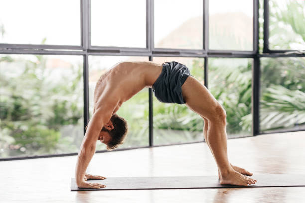 istock Yoga men workout in studio in front of a window 1283116082