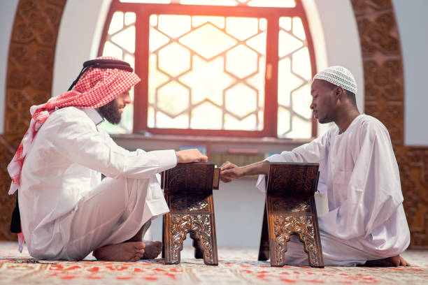 istock Two religious muslim man praying together inside the mosque 1283117572