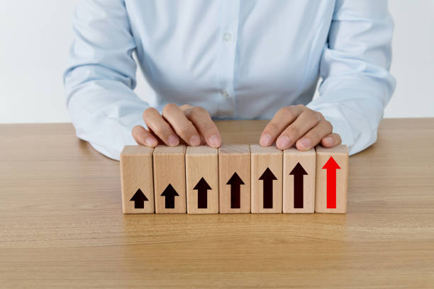 istock Wooden blocks with arrow up 1283119123