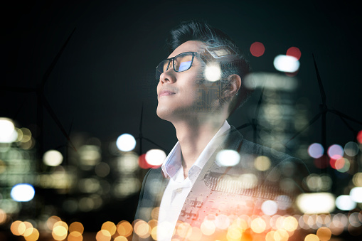 Asian businessman investor abstract smart vision CPU overlay financial business district night city futuristic background, investment and business with artificial intelligence digital technology.