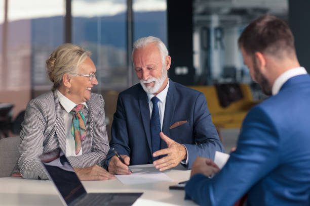 istock Positive aged couple consulting with insurance agent 1283119874