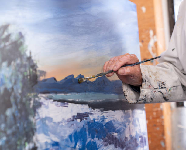 istock Man painting abstract art on canvas in studio 1283120652
