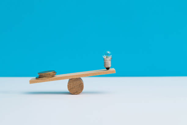 istock Seesaw with light bulb and coins 1283121432