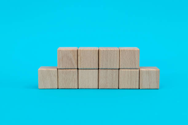 istock Wooden blocks in a row on blue background 1283123113
