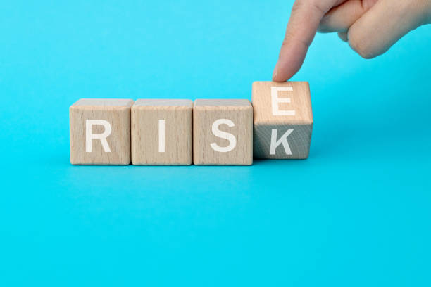 istock Wooden cubes with word rise and risk 1283123895