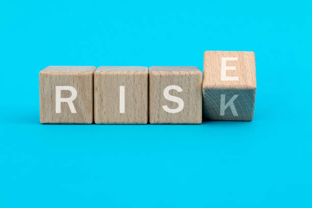 istock Wooden cubes with word rise and risk 1283123915