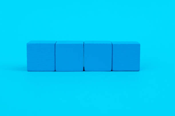 istock Wooden blocks in a row on blue background 1283125961