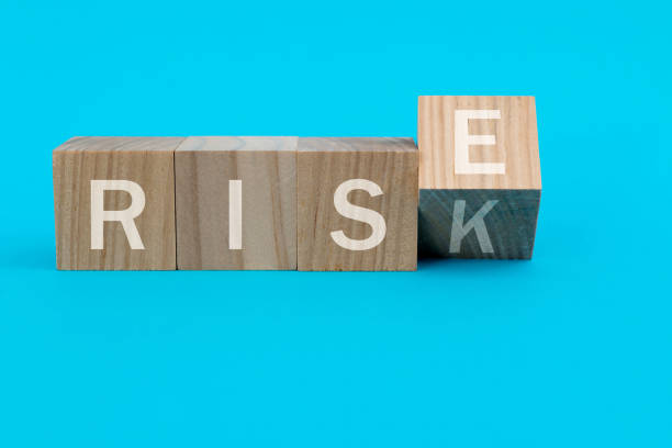 istock Wooden cubes with word rise and risk 1283126854