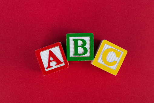 Multicolored plastic letters A, B and C isolated on white background