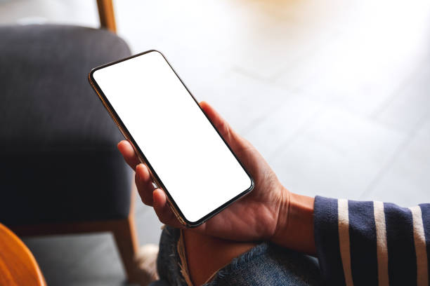 istock a woman holding mobile phone with blank white desktop screen 1283127522