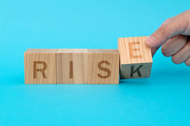 istock Wooden cubes with word rise and risk 1283127589