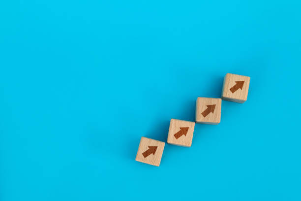 istock Wooden blocks with arrow up 1283127864