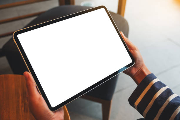 istock a woman holding digital tablet with blank white desktop screen 1283128457