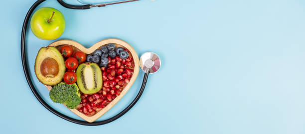 istock fruit and Vegetable; Blueberries, cherry Tomatoes, Avocado, Broccoli, Kiwi and green apple on blue background. weight loss, nutrition, Healthy food, Dieting and vegetarian concept 1283129835