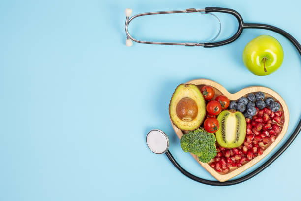 istock fruit and Vegetable; Blueberries, cherry Tomatoes, Avocado, Broccoli, Kiwi and green apple on blue background. weight loss, nutrition, Healthy food, Dieting and vegetarian concept 1283129948