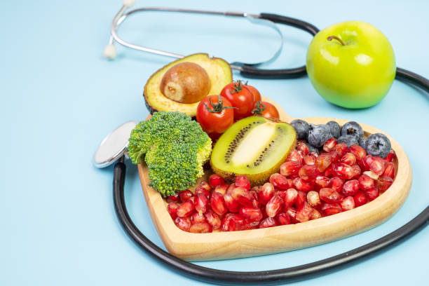 istock fruit and Vegetable; Blueberries, cherry Tomatoes, Avocado, Broccoli, Kiwi and green apple on blue background. weight loss, nutrition, Healthy food, Dieting and vegetarian concept 1283130981