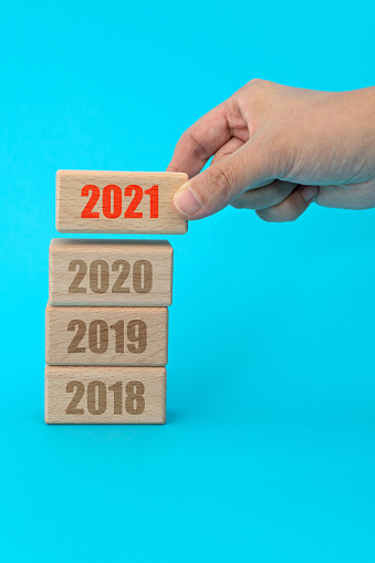 2018, 2019, 2020, 2021 written on wooden blocks.