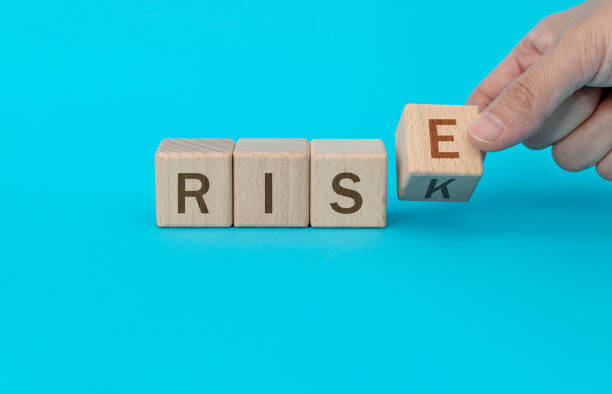 istock Wooden cubes with word rise and risk 1283131622