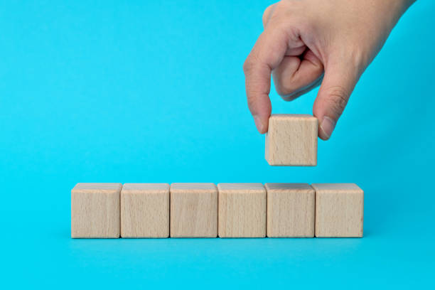 istock Wooden blocks in a row on blue background 1283131791