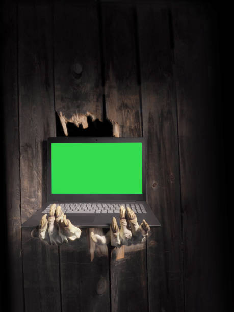 istock Zombie hand through hole cracked in rustic wood.Halloween theme 1283132657