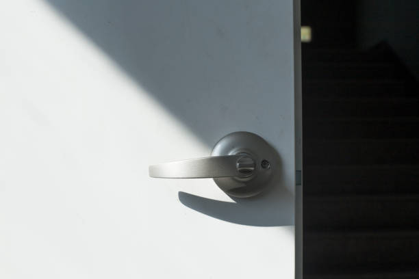 istock door handle on a white door with the lock iron in the background. 1283133036