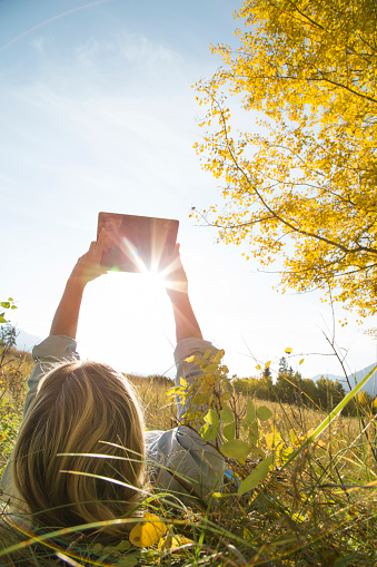 Sun flares behind tablet