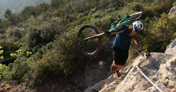 istock Mountain biker uses cable to ascend a mountain ridge 1283134871