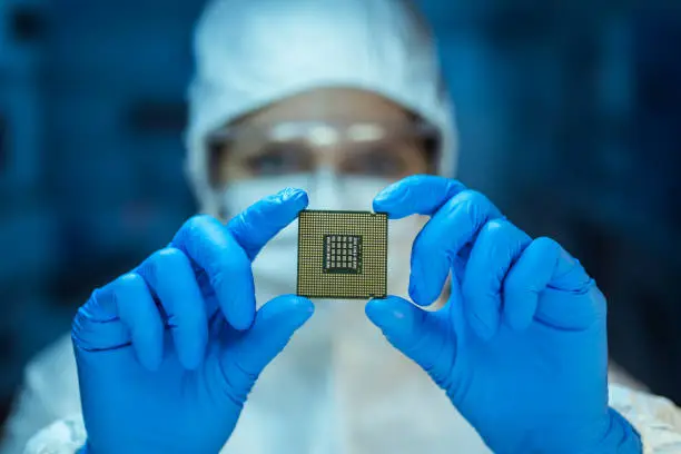 Engineer analyzing computer chip in laboratory