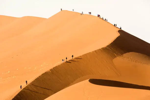 Tourist's climbing a sand dune. Sossusvlei,Namibia.