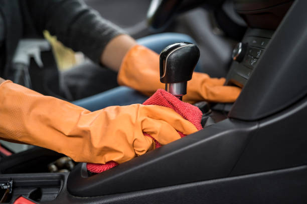 istock hand in protective gloves cleaning car interior from coronavirus covid-19 using microfiber clothes 1283140816
