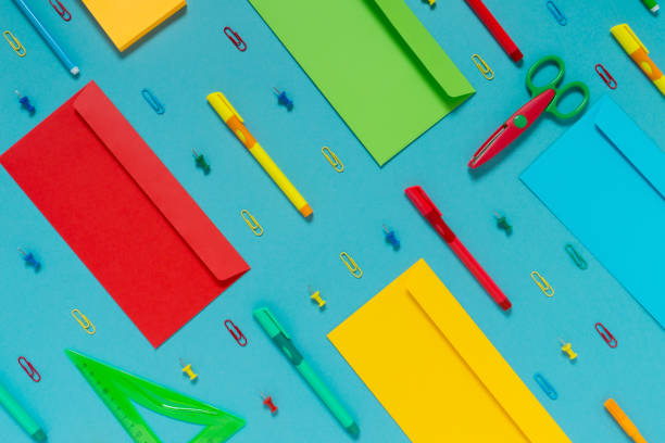 istock Flat lay of bright multi colored office supplies on a blue background. Top view 1283142096
