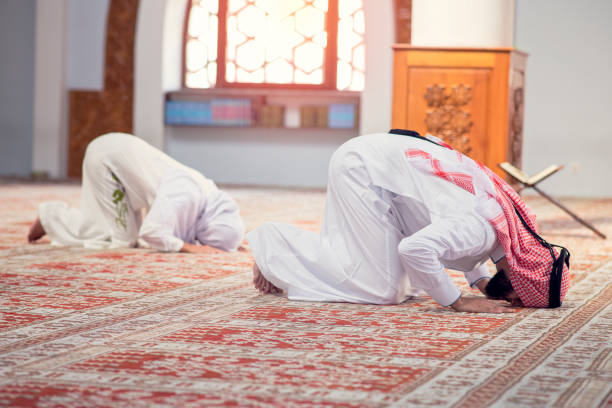 istock Muslim Couple Praying inside of beautiful mosque 1283143695