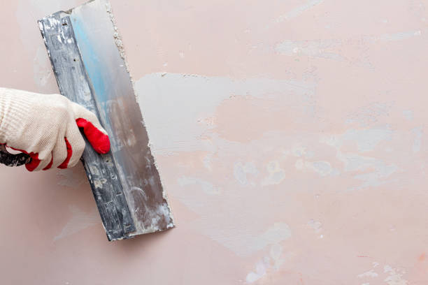 istock Puttying, sealing cracks with gypsum plaster using a spatula. Damaged wall repair. 1283147426