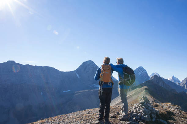 istock Father and son relax on sunny mountain range in the morning 1283149520