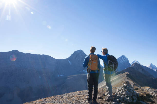 istock Father and son relax on sunny mountain range in the morning 1283149620
