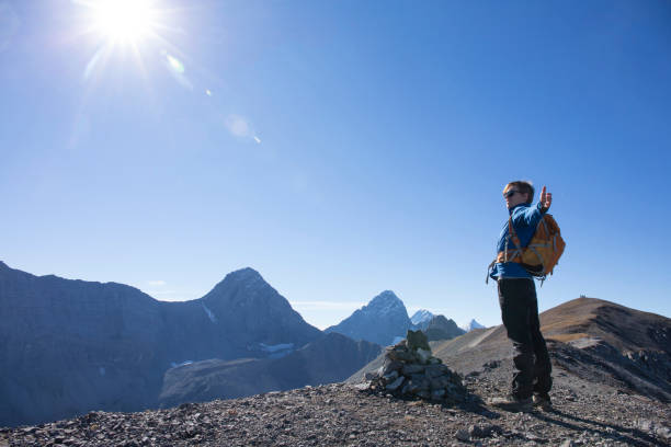 istock Young man hikes along mountain ridge in the morning 1283149899
