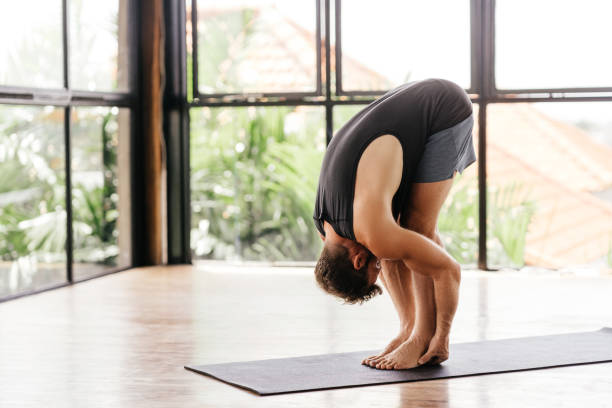 istock Yoga men workout in studio in front of a window 1283150029