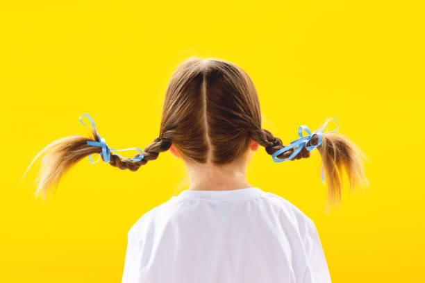 istock The girl's back on a yellow background 1283151191