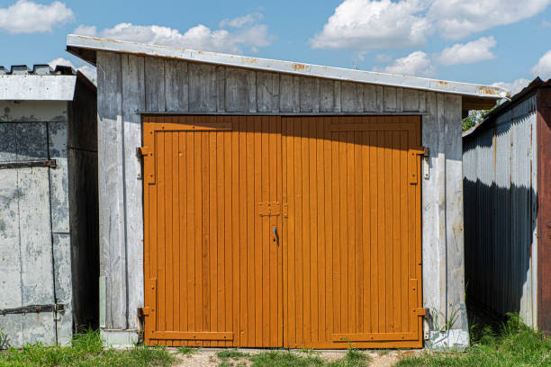 istock Rusty brown garage door closed with a vintage latch and padlock or hasp 1283153370
