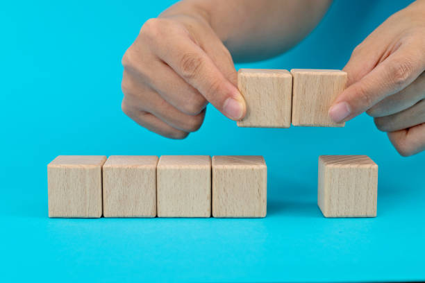 istock Wooden blocks in a row on blue background 1283154018
