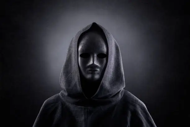 Portrait of a scary figure in hooded cloak