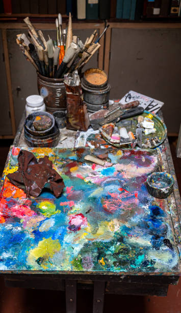 istock Artistic paintbrushes, paints and palette knifes 1283155518