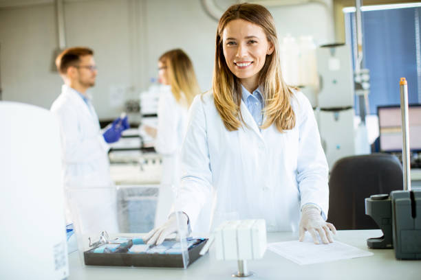 istock Female scientist in white lab coat standing in the biomedical lab 1283155748