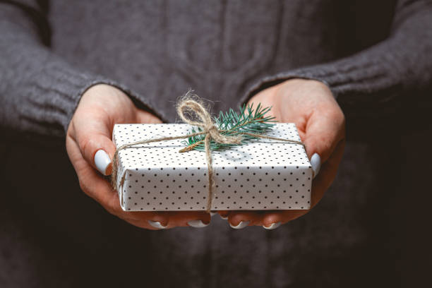 istock Cute Christmas gift in female hands 1283155961